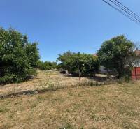 Land for sale in Mužla for residential purposes, surrounded by greenery and a fence.