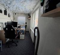 A workspace in a family house with gaming consoles on a light wall.