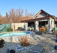 A family house in Žitavce on Žitavská Street with a circular pool and a garden terrace.