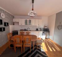 A kitchen in a family house with wooden furniture and a floor with a wooden decor.