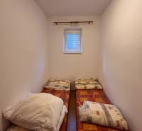 A cozy room with two beds in a family house.