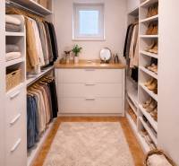 A wardrobe in a family house with shelves, storage space, and a beige carpet.