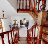 Wooden stairs and a wooden decor floor in a family house with vintage furniture.