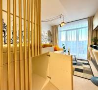 Interior of a 1-room apartment with armchairs, wall drawing, and built-in wardrobe.