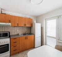 Offices with a kitchenette, tiles, wooden decor cabinets, refrigerator, and microwave oven.