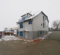 Office building on Bratislavská Road in Trenčín with a parking lot and snowy surroundings.