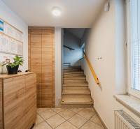 A staircase with a wooden decor and documents on the wall in the office.