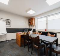 Offices with a large window, desk and chairs, floor with wooden decor.