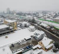 Snow-covered offices and buildings on Bratislavská Street in Trenčín during winter.