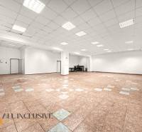 Spacious commercial premises with ceramic tiles and white walls.