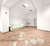 Commercial premises with ceramic flooring, white seating, and a sink.