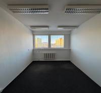 A bright office with skylights and a view of the buildings of Poprad.