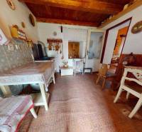 A kitchen in a family house with rustic furniture and decorations on the walls.