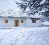 A family house on Stará Huta 84 street covered with snow in a winter landscape.
