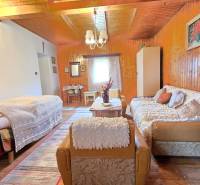 Living room in a family house with wooden paneling and comfortable furniture.