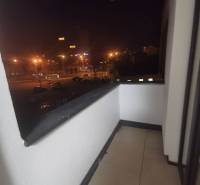 The balcony of a 2-room apartment with a view of the night panorama of Poprad.