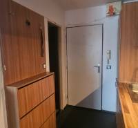 The studio apartment has a kitchenette with cabinets and a sink with a modern faucet.