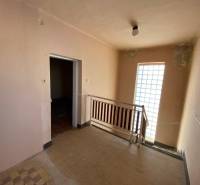 Interior of a family house with a wooden decor floor and a staircase.