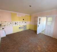 The interior of a family house with a wooden decor floor and colorful walls.