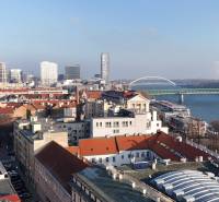 A view of the city skyline of Bratislava from Vajanského nábrežie with a bridge over the Danube River.