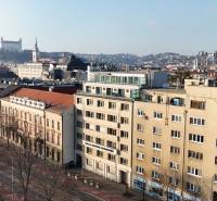View of the Vajanského Embankment Building with Bratislava Castle in the background.
