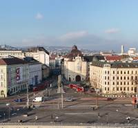 A view of Bratislava with historical architecture and busy traffic on Vajanského Embankment.
