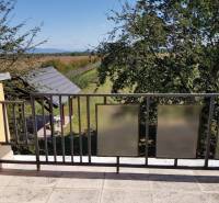 A balcony in a family house in Stretavka with a view of nature and a gazebo.