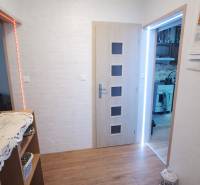 Interior of a family house with a wooden decor floor and white walls.