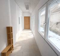 Bright hallway in a family house with a shelf and a view of the snowy exterior.