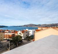 View from the terrace of a 3-room apartment in the city of Trogir to the sea and surrounding rooftops.