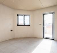 A bright room with a tiled floor and large plastic windows in a 3-room apartment.