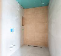 A bathroom in a 3-room apartment with tiles in neutral colors, ready for completion.