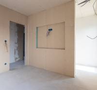Interior of a 3-room apartment with unfinished walls and flooring.