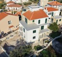 A construction project in Trogir with red roofs and surrounding family houses.