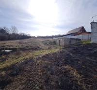 Land on Poľná Street in Banka designated for residential use with a visible structure and fence.