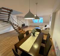 Dining room and living room with wood-patterned flooring in a 3-room apartment.