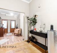 Entrance hall in a family house with decorations and wood-patterned flooring.