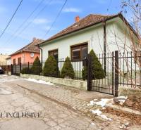 Family house in Orechová Potôň on Čečínská Potôň with a fence and conifers in front of the house.