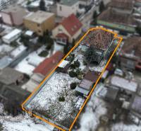 A family house with a garden in Čečínska Potôň in Orechová Potôň during winter.