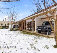 Exterior of a family house in Dolný Štál with a terrace and a car on a snowy plot.