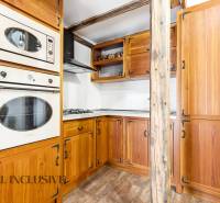 Rustic kitchen in a family house with wooden cabinets and a wooden decor floor.
