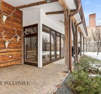 The exterior of a family house in Dolný Štál with decorative skulls on the wooden wall.