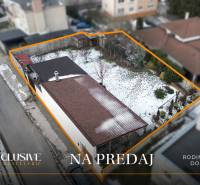 A family house in Dolný Štál for sale, a snow-covered garden bordered by an orange line.