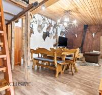 Interior of a family house with wooden stairs, hunting trophies, and a floor with a wooden decor.