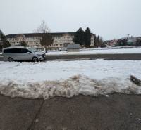 Snow cover, Remeselnícka Street in Ľubica, a minivan is parked on the road in front of a building.