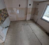 Empty room with tiled walls in a family house.