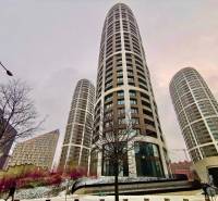 High-rise buildings on Bottova Street in Bratislava - Old Town, snowy surroundings and trees.