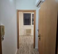 Offices with wood-patterned flooring and air conditioning.