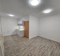 Offices with a kitchenette and flooring with a wood decor.