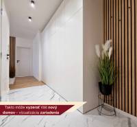 A hallway with white cabinets and a decorative wall in a 3-room apartment.